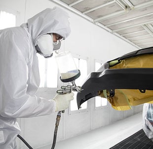 Collision Center Technician Painting a Vehicle | Peppers Toyota in Paris TN